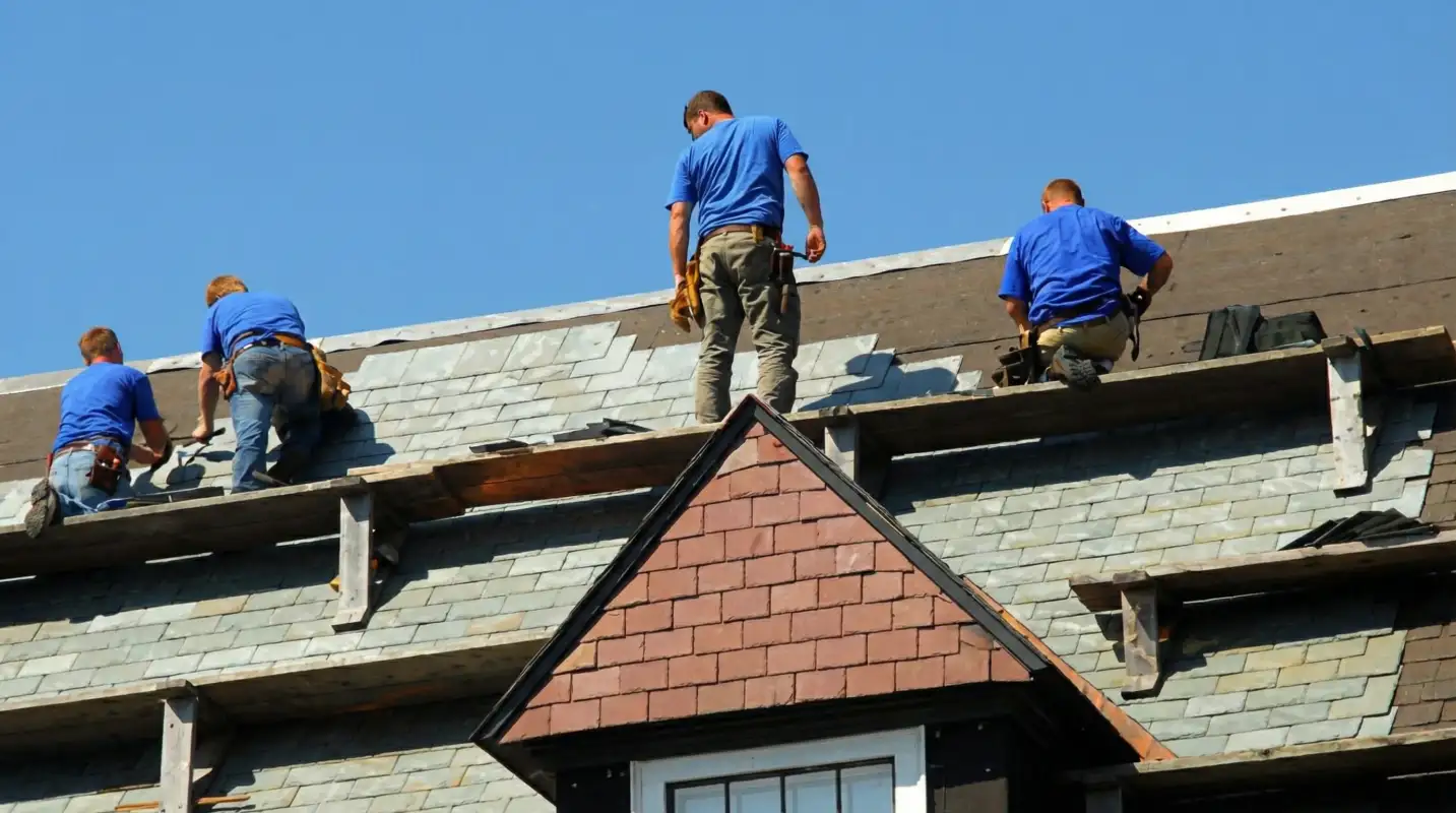Roof replacement in progress with a team of professional contractors installing new shingles on a residential home in Irvine, CA